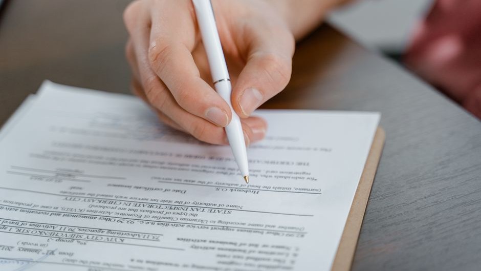 Hand writing and editing notes on a printed page.