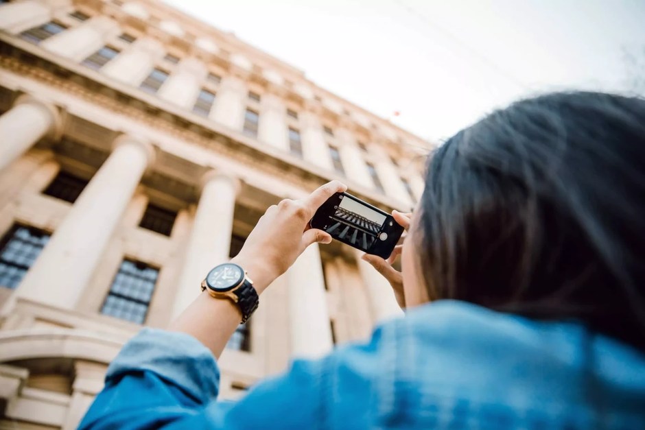Photographer taking a picture of city architecture