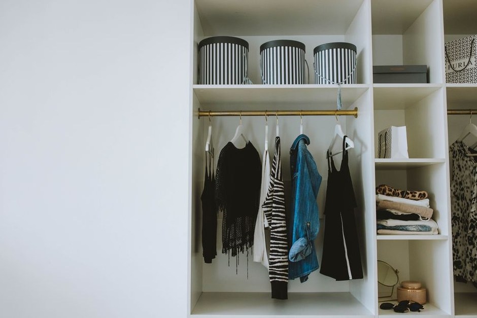 Open wardrobe with neatly arranged everyday clothes